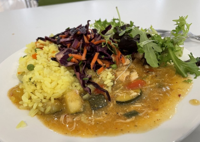 A plate filled with thai currey and rice